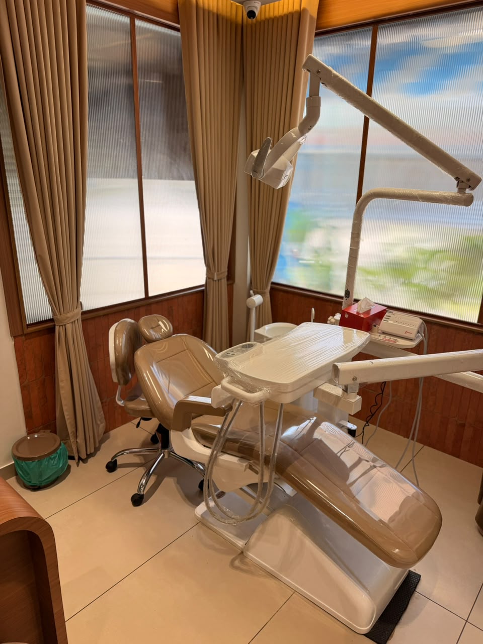 Dental chair beside the clinic windows